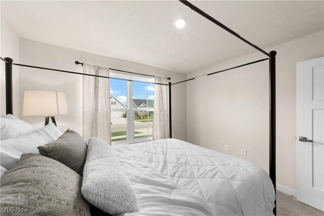 carpeted bedroom featuring a textured ceiling