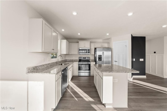 kitchen featuring a center island, sink, white cabinetry, and stainless steel appliances