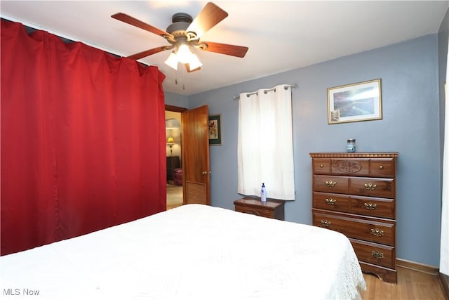 bedroom with ceiling fan and light hardwood / wood-style flooring