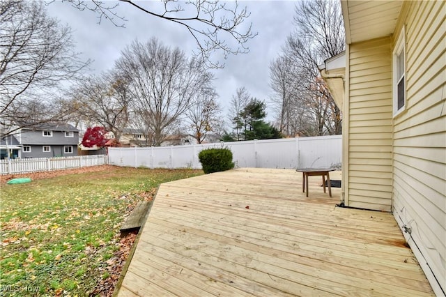 wooden deck featuring a lawn