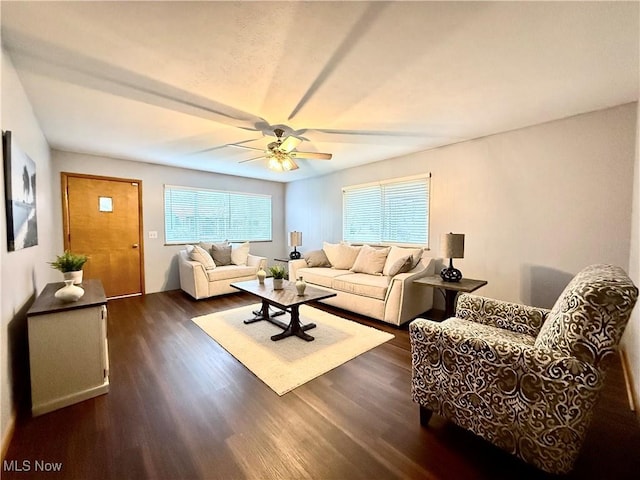 living room featuring dark hardwood / wood-style floors and ceiling fan