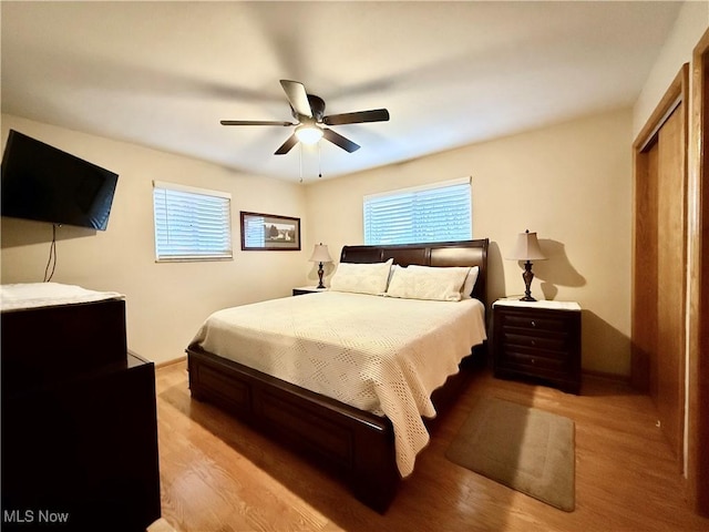 bedroom with a closet, ceiling fan, and light hardwood / wood-style flooring