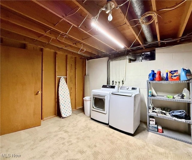 clothes washing area featuring washer and clothes dryer