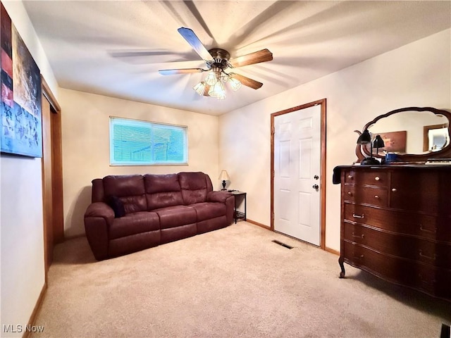 living room with light carpet and ceiling fan