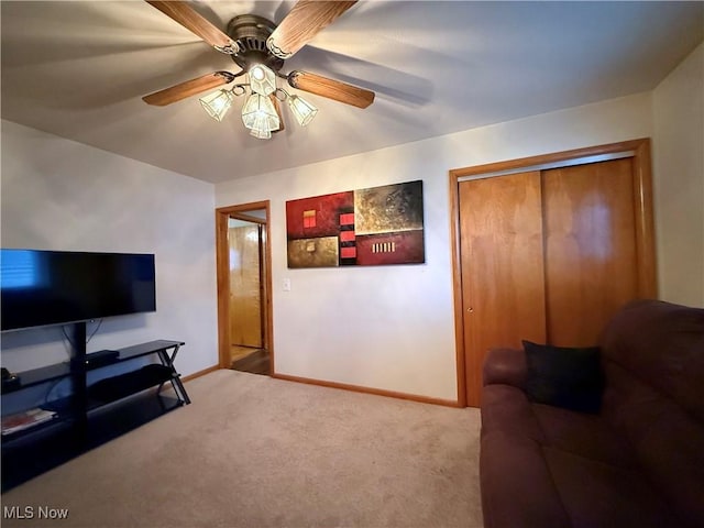 living room featuring ceiling fan and carpet flooring