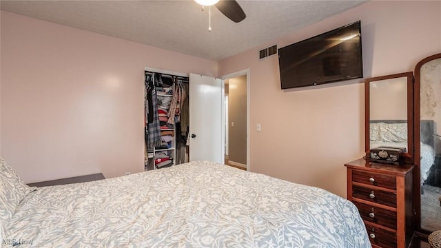 bedroom with a textured ceiling, a closet, and ceiling fan