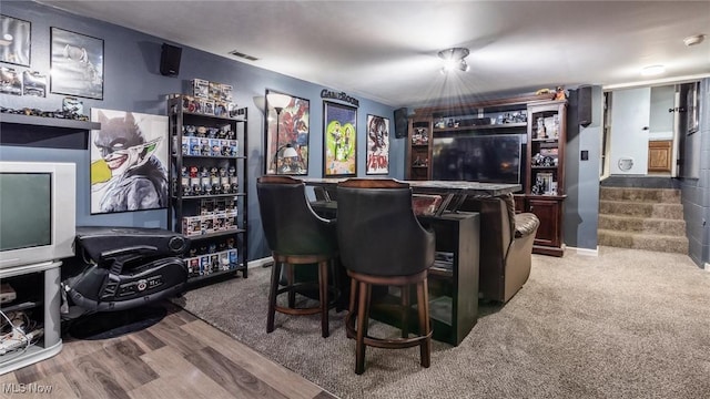 bar with hardwood / wood-style floors