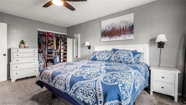 carpeted bedroom with ceiling fan, a textured ceiling, and a closet