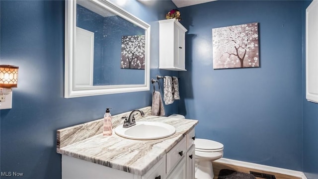 bathroom with vanity and toilet