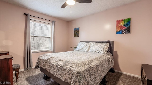 carpeted bedroom featuring a textured ceiling and ceiling fan