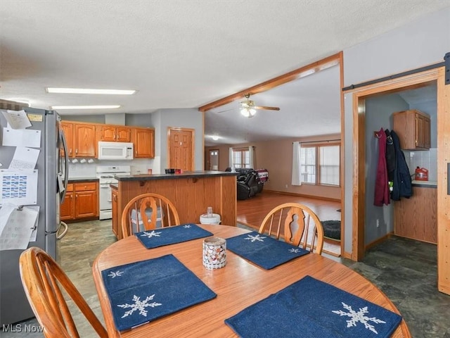 dining space with lofted ceiling with beams, ceiling fan, and dark wood-type flooring