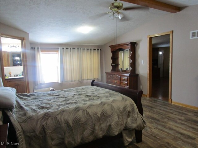 bedroom with vaulted ceiling with beams, ceiling fan, dark wood-type flooring, and a textured ceiling