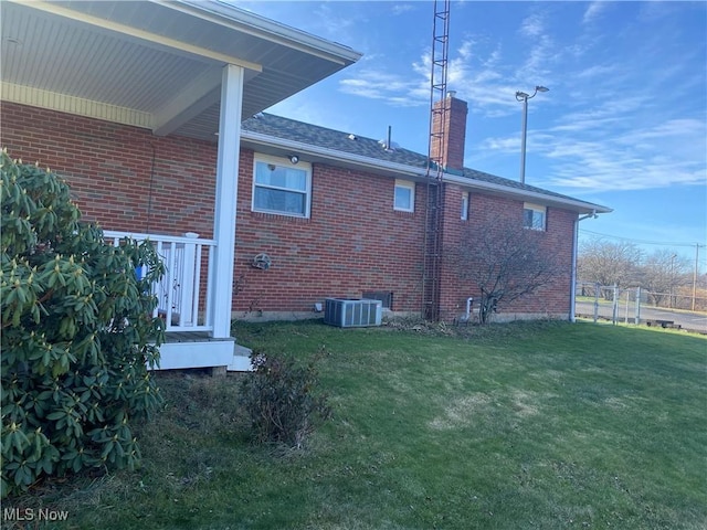 rear view of property featuring a lawn