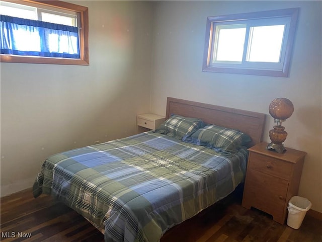 bedroom with dark hardwood / wood-style floors