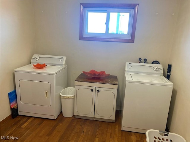 clothes washing area with cabinets, dark hardwood / wood-style floors, and independent washer and dryer