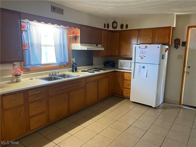 kitchen featuring white appliances, sink, and light tile patterned floors