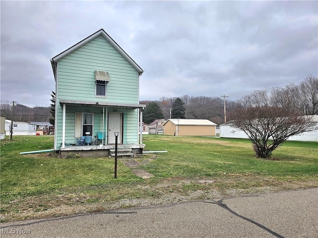 exterior space with covered porch and a front yard