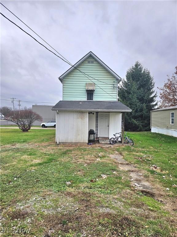 rear view of house with a lawn