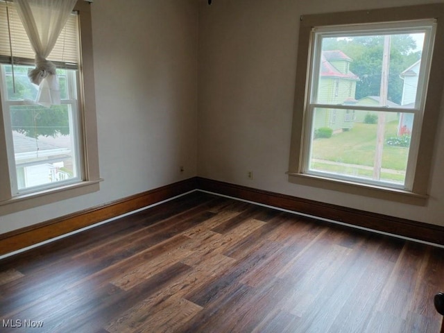 spare room featuring dark hardwood / wood-style floors