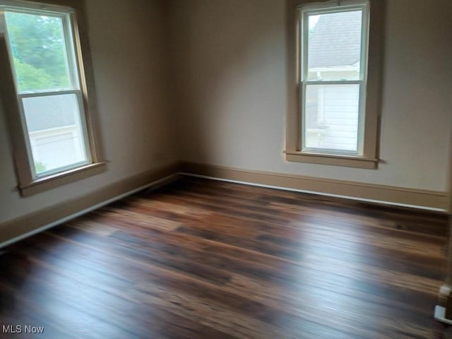 unfurnished room featuring dark hardwood / wood-style flooring