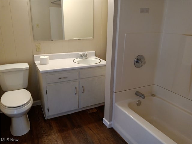 full bathroom with bathtub / shower combination, wood-type flooring, vanity, and toilet