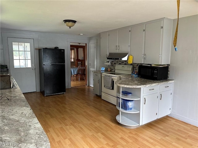 kitchen featuring black appliances, light hardwood / wood-style floors, and backsplash