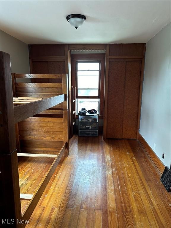 unfurnished bedroom with a closet and wood-type flooring