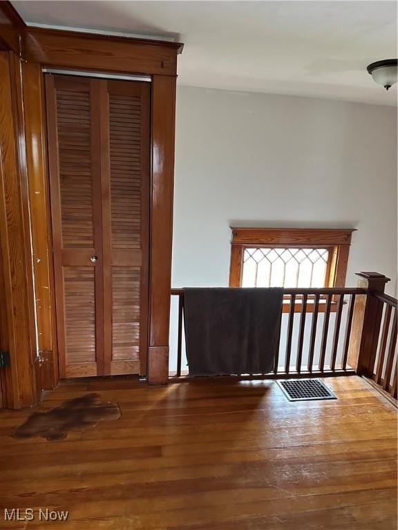 unfurnished bedroom with a closet and hardwood / wood-style floors