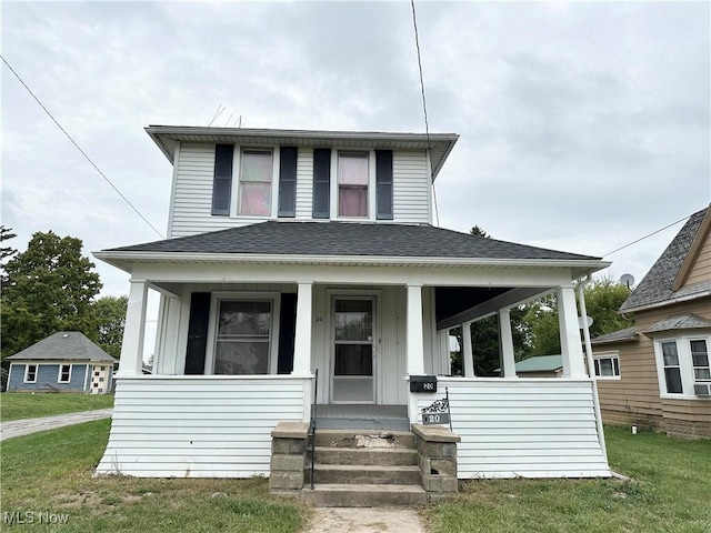 view of front of property featuring covered porch and a front yard