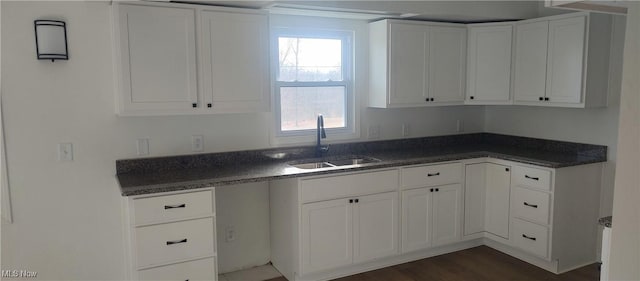 kitchen with white cabinets, sink, and dark wood-type flooring