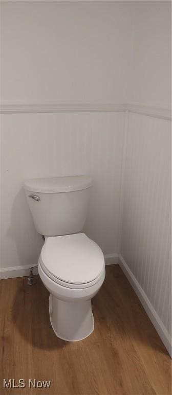 bathroom featuring wood-type flooring and toilet