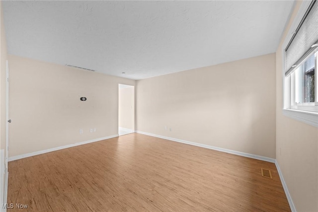 spare room featuring light wood-type flooring