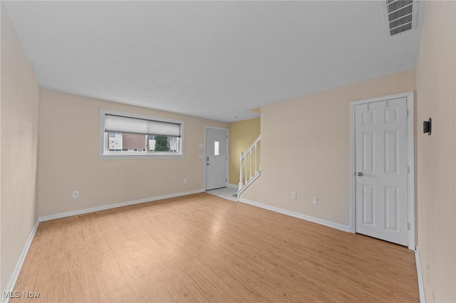 spare room with light hardwood / wood-style floors