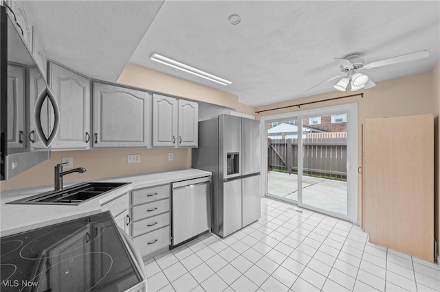 kitchen featuring sink, ceiling fan, gray cabinets, light tile patterned floors, and stainless steel appliances