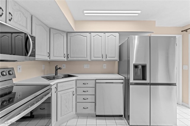 kitchen featuring light tile patterned floors, sink, and appliances with stainless steel finishes