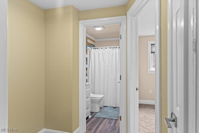 bathroom featuring hardwood / wood-style floors and toilet