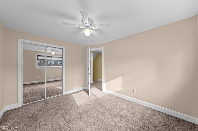 unfurnished bedroom featuring ceiling fan, carpet floors, and a closet