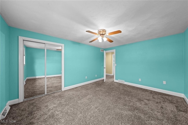 unfurnished bedroom with ceiling fan, a closet, and carpet floors