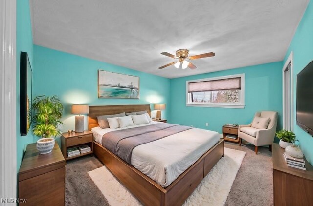 carpeted bedroom featuring ceiling fan