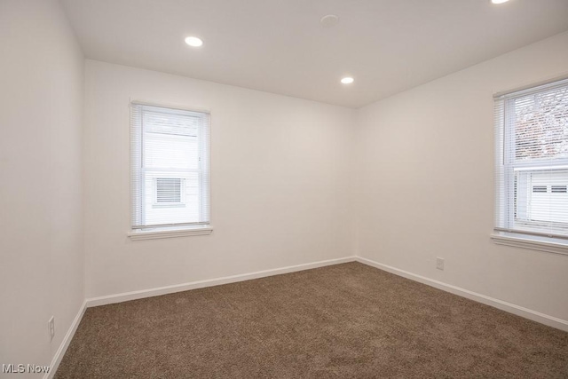 carpeted empty room featuring plenty of natural light