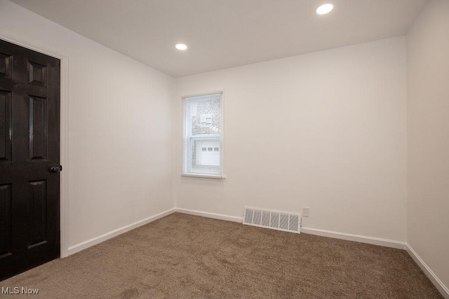 unfurnished room featuring carpet