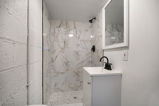 bathroom with vanity and tiled shower