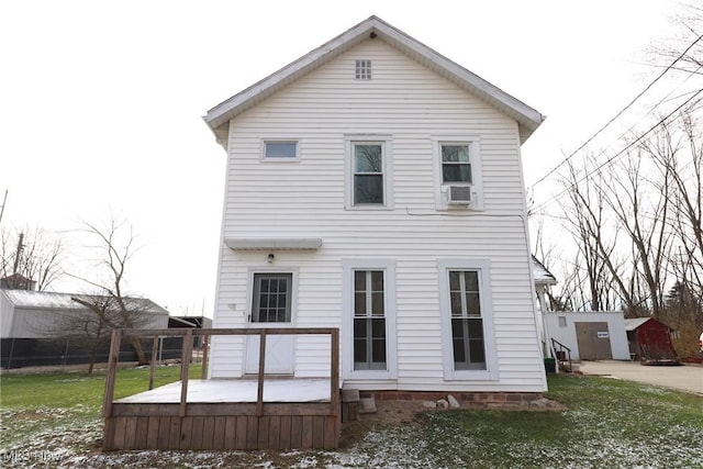 rear view of property with a storage unit, cooling unit, a yard, and a wooden deck