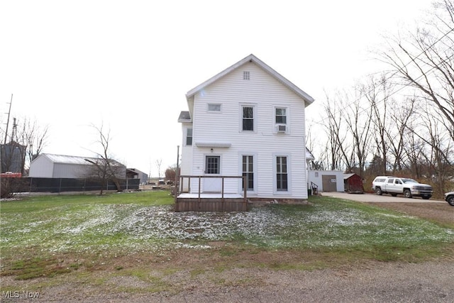 rear view of property featuring a yard