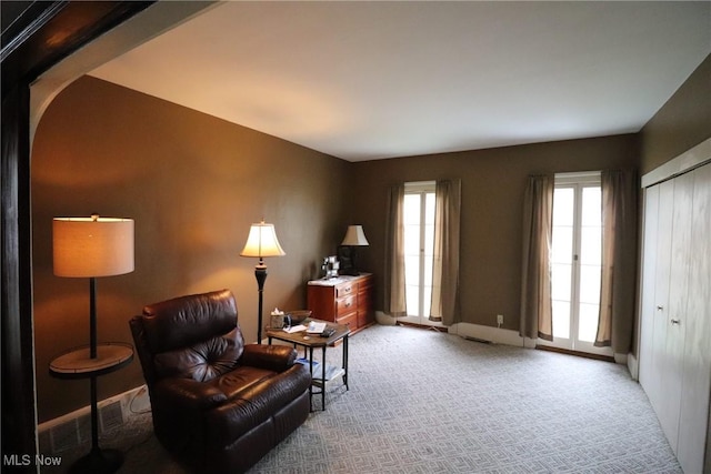 living area featuring light colored carpet