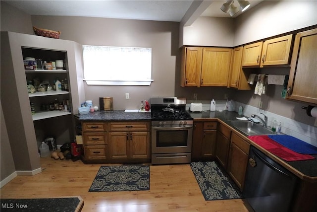 kitchen with sink, stainless steel appliances, and light hardwood / wood-style flooring