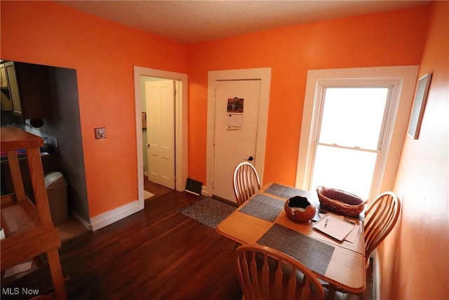 dining space with dark wood-type flooring