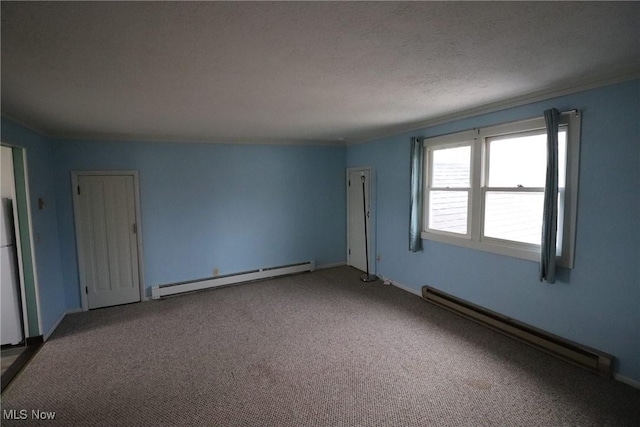 carpeted spare room featuring a textured ceiling and a baseboard radiator