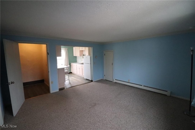 interior space featuring a textured ceiling, light colored carpet, and baseboard heating