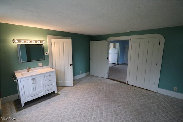 bathroom with vanity and a textured ceiling